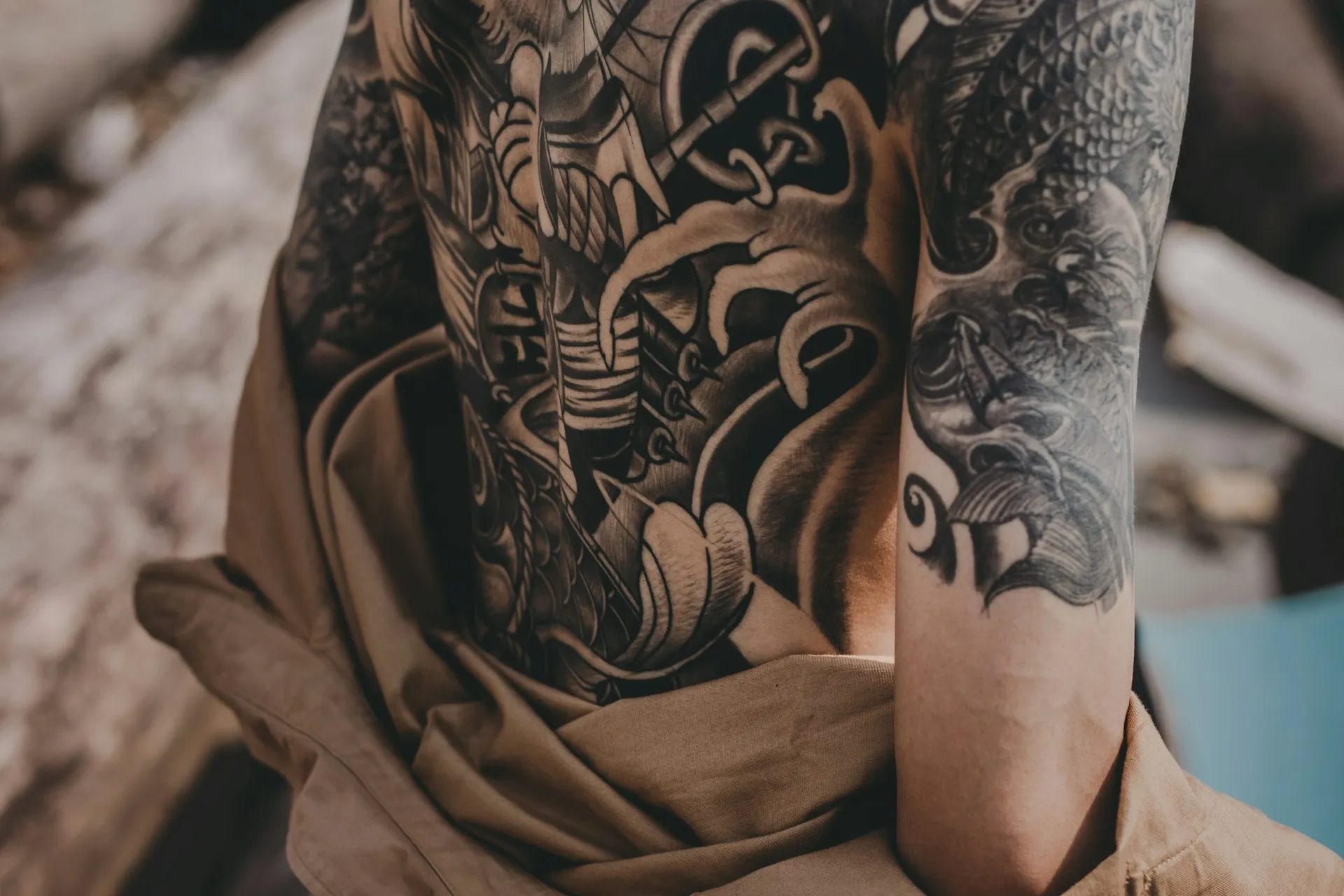 Tattoo artist applying bold traditional American tattoo design